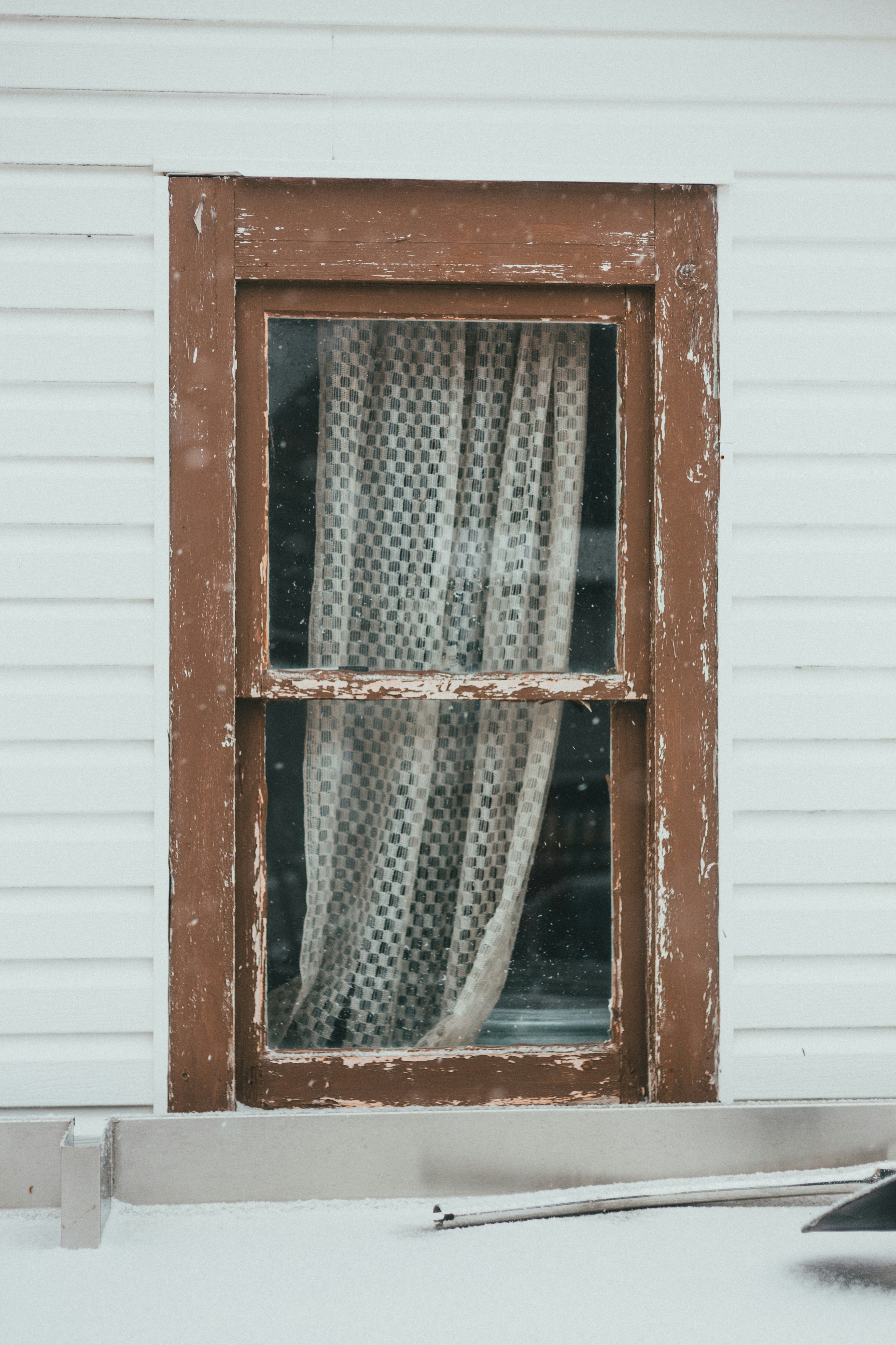 brown wooden framed glass window